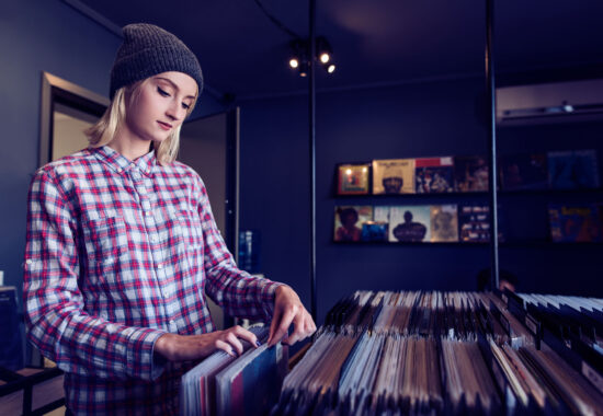 beautiful young woman browsing records in the vinyl record store beautiful young woman browsing records in the vinyl record store