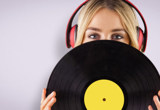 Composite image of portrait of a beautiful woman holding a vinyl 681398