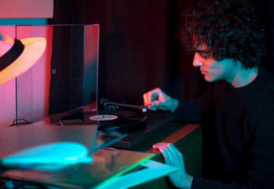 Guy listens to a vinyl record Portrait of young Guy listens to a vinyl record