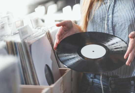 Young woman with music records indoors Young woman with music records in a store
