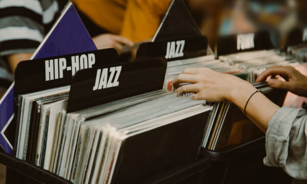 Woman is choosing a vinyl record in a musical store Woman is choosing a vinyl record in a musical store